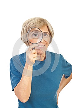 Funny senior woman with magnifier