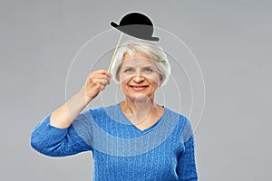 Funny senior woman with vintage party hat