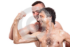 Funny shirtless men compare biceps