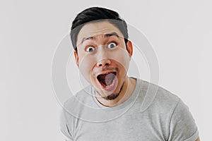 Funny shocked surprised closeup face man isolated on white background.