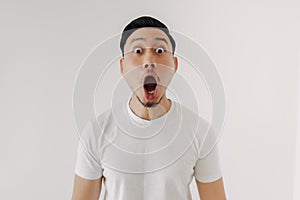 Funny shocked and surprised face of man isolated on white background.