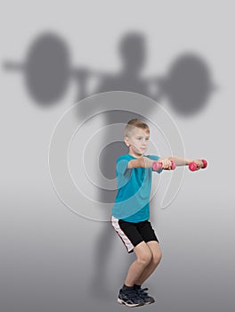 Boy doing squat exercises with weightlifter's silhouette behind him