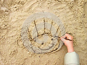 Funny smiley on wet sand