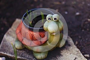 Funny smiling ceramic turtle in the garden