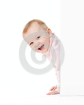 Funny smiling girl look out of wall