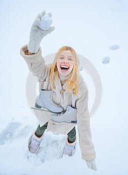 Funny smiling young woman in wintertime outdoor. Wearing funny hat plaid scarf and coat. Happy winter fun woman. Winter