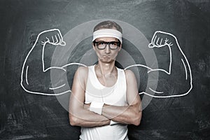 Funny nerd with fake muscle drawn on the chalkboard