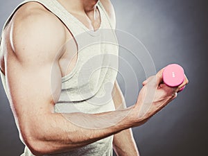 Funny sporty fit man lifting light dumbbell. Fun.