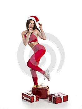 Funny sporty woman with new year and christmas gifts isolated on white background. X-mas fun and sport concept
