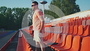 Funny stressed latin caucasian spanish man on the stadium tribune cheering for his favorite team alone.