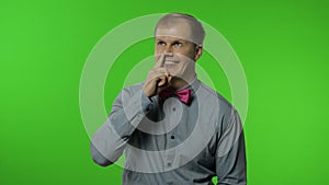 Funny stupid man picking nose. Silly brainless humorous expression, removing boogers, bad manners photo