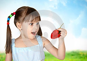 Funny surprised child girl with strawberry