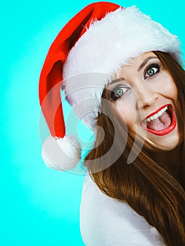 Funny surprised woman in Christmas Santa hat