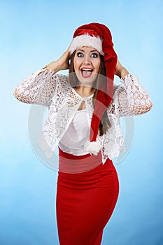 Funny surprised woman in Christmas Santa hat