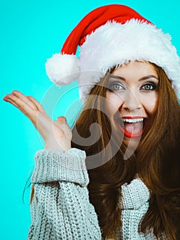 Funny surprised woman in Christmas Santa hat