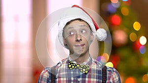 Funny teen boy in Christmas hat.