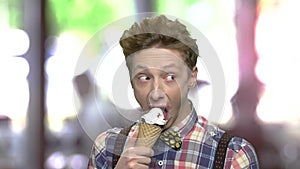 Funny teen boy eating an ice cream.