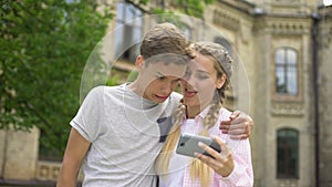 Funny teen couple taking selfie, making faces and fooling around, leisure time