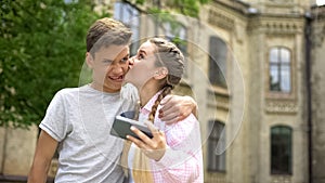 Funny teen couple taking selfie, making faces and fooling around, leisure time