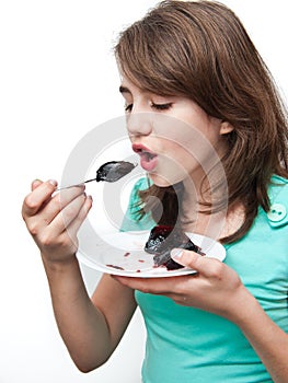 Funny teen girl eating charlotte isolated on white