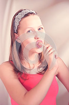 Funny teen girl eating lollypop