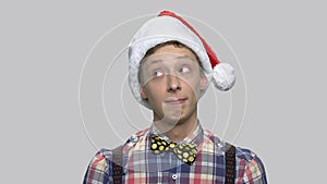 Funny teen guy in Santa Claus hat.