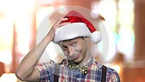 Funny teenage boy in Christmas hat.