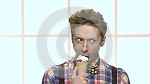 Funny teenage boy eating ice cream.