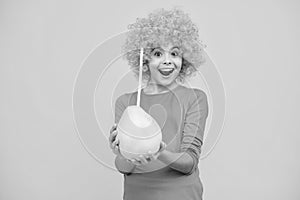 Funny teenage girl hold citrus fruit pummelo or pomelo, big green grapefruit isolated on yellow background. Excited