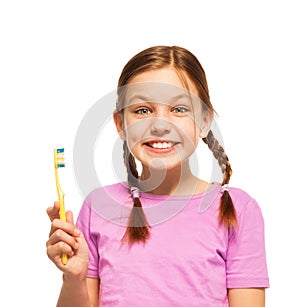 Funny teenage girl in pink tee brushing her teeth