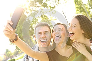 Funny teens taking selfie and joking photo