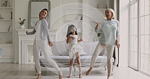 Funny three age generation women family dancing in living room