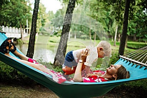 Young mother and little son in the park in the spring at sunset. Happy family. Weekend playtime concept