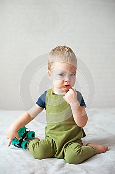 Funny toddler boy playing with toy car
