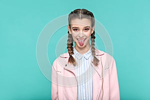 Funny tongue out portrait of beautiful cute girl standing with m