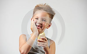 Funny toothless boy with sensitive teeth holding ice cream