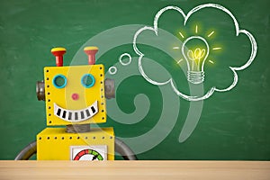 Funny toy robot teacher against chalkboard