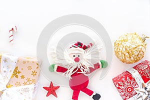 Funny toy santa claus, gift boxes, star and christmas ball on a white background.