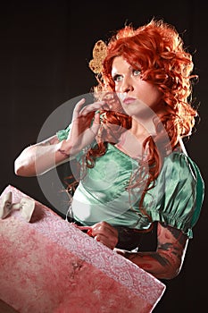 Funny traveler. Studio portrait of young girl dreaming about vacation