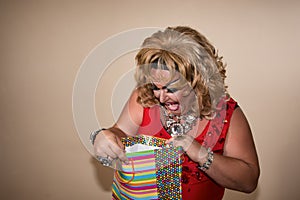 Funny travesty actor. Drag queen and gift. Fat man and make-up