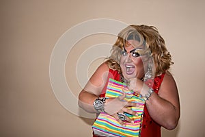 Funny travesty actor. Drag queen and gift. Fat man and make-up
