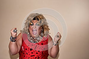 Funny travesty actor. Drag queen in red. Feelings and emotions