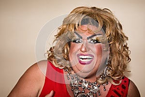 Funny travesty actor. Drag queen in red. Feelings and emotions