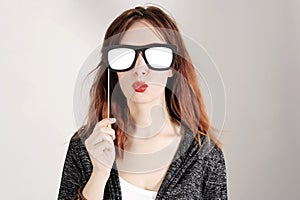 Funny trendy fashion girl with paper glasses playing with emotion