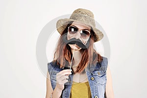 Funny trendy fashion girl with paper mustache playing with emotion