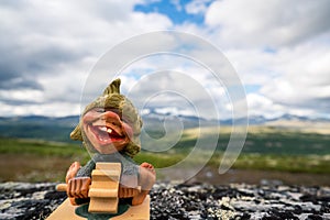 Funny troll figure with water wheel waiting for rain to make electricity