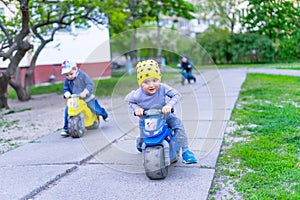 Funny two active little boys riding on bicycle on warm summer day. Countryside. Active leisure and sports for kids.Funny cute chil