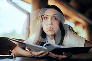 Funny Undecided Woman Checking the Menu in a Restaurant