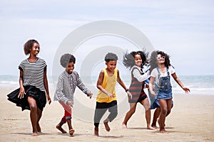 Funny vacation. Children or kids playing and romp together at the beach on holiday. Having fun after unlocking down the city from