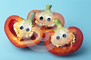 Funny vegetables for kids. Cheerful Peppers with eyes and smiles. Food for kids concept